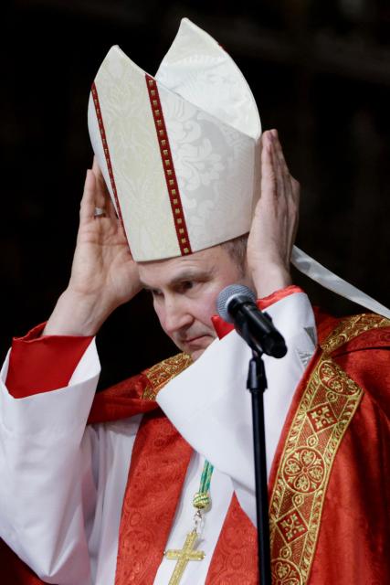 Archibishop-designate Ronald Hicks adjusts his mitre during Solemn Vespers evening prayer service, ahead of his installation as New York Archbishop at St. Patrick's Cathedral in New York on February 5, 2026. In a significant shift for the US Catholic Church, Pope Leo XIV replaced Timothy Dolan, who stepped down after reaching the church's retirement age of 75, with Hicks, a 58-year-old bishop from Illinois. (Photo by Leonardo Munoz / AFP)