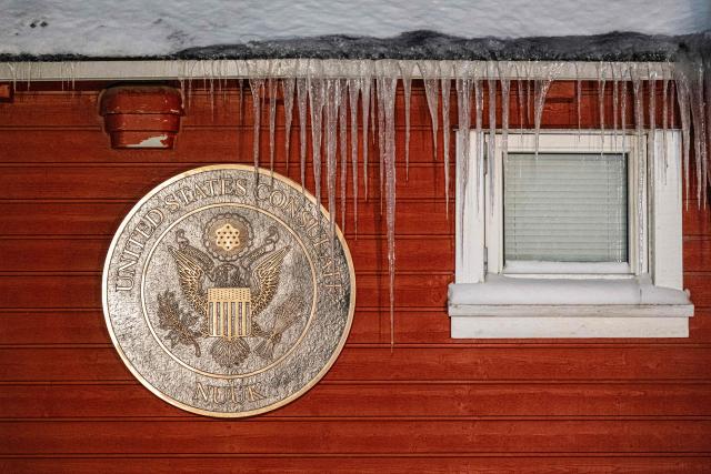 (FILES) Icicles hang above a sign of the United States Consulate in Nuuk, Greenland, on January 20, 2026. Canada and France, which both adamantly oppose Donald Trump's wish to control Greenland, will open consulates in the Danish autonomous territory's capital on February 6, 2026, a strong show of support for the local government. (Photo by Jonathan NACKSTRAND / AFP)
