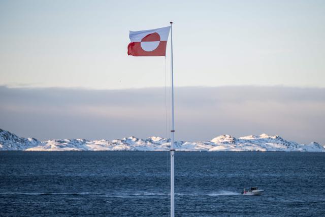 (FILES) A Greenland flag flutters at the coastline in Nuuk, Greenland, on January 20, 2026. Canada and France, which both adamantly oppose Donald Trump's wish to control Greenland, will open consulates in the Danish autonomous territory's capital on February 6, 2026, a strong show of support for the local government. (Photo by Jonathan NACKSTRAND / AFP)