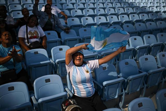 Argentine fans cheer as they attend to the 2026 Series of the Americas match between Argentina's Club Daom and Curacao's Goats at the Monumental Simon Bolivar Stadium in Caracas on February 5, 2026. (Photo by Federico PARRA / AFP)