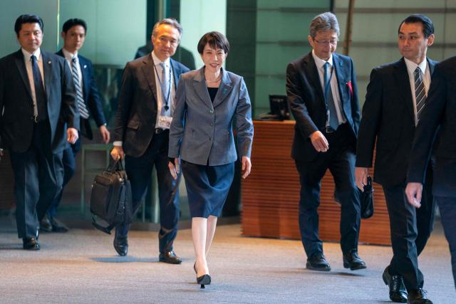 This photo taken on February 5, 2026 shows Japan's Prime Minister Sanae Takaichi (C) entering the Prime Minister's office between election campaign activities in Tokyo. Sanae Takaichi, a staunch conservative who admires Margaret Thatcher, became Japan's first woman prime minister in October but has shown little appetite for framing her leadership around gender. (Photo by Kazuhiro NOGI / AFP) / To go with AFP story Japan-vote-Takaichi, PROFILE