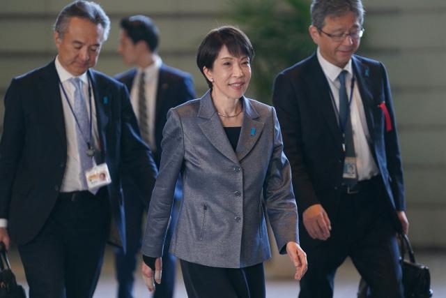 This photo taken on February 5, 2026 shows Japan's Prime Minister Sanae Takaichi (C) entering the Prime Minister's office between election campaign activities in Tokyo. Sanae Takaichi, a staunch conservative who admires Margaret Thatcher, became Japan's first woman prime minister in October but has shown little appetite for framing her leadership around gender. (Photo by Kazuhiro NOGI / AFP) / To go with AFP story Japan-vote-Takaichi, PROFILE