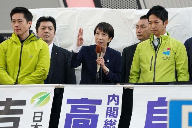 This photo taken on January 27, 2026 shows Japan's Prime Minister and President of the Liberal Democratic Party Sanae Takaichi (C) delivering her campaign speech for the House of Representatives election alongside co-leaders of the Japan Innovation Party Hirofumi Yoshimura (L) and Fumitake Fujita (R) in Tokyo. Sanae Takaichi, a staunch conservative who admires Margaret Thatcher, became Japan's first woman prime minister in October but has shown little appetite for framing her leadership around gender. (Photo by Kazuhiro NOGI / AFP) / To go with AFP story Japan-vote-Takaichi, PROFILE