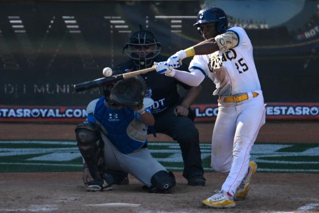 Curacao's Goats pitcher Manuel Cachutt (R) hit the ball during the 2026 Series of the Americas baseball game against Argentina's Club Daom at the Monumental Simon Bolivar Stadium in Caracas on February 5, 2026. (Photo by Federico PARRA / AFP)