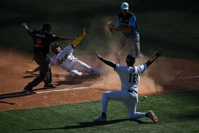 Curacao's Goats outfielders Nicholl Para (C) is safe at third base during the 2026 Series of the Americas baseball game against Argentina's  Club Daom at the Monumental Simon Bolivar Stadium in Caracas on February 5, 2026. (Photo by Federico PARRA / AFP)