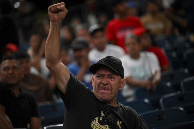 A Venezuelan fan cheers for his team during a game of the 2026 Series of the Americas between Venezuela's Navegantes del Magallanes and Panama's Aguilas Metropolitanas at the Simon Bolivar Monumental Stadium in Caracas on February 5, 2026. (Photo by Federico PARRA / AFP)