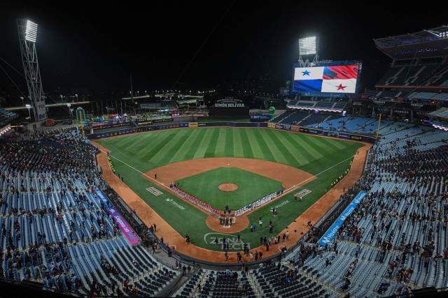 Players of both teams hear their national anthems ahead of the 2026 Series of the Americas baseball game between Venezuela's Navegantes del Magallanes and Panama's Aguilas Metropolitanas at the Simon Bolivar Monumental Stadium in Caracas on February 5, 2026. (Photo by Federico PARRA / AFP)