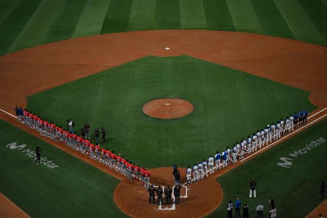 Players of both teams hear their national anthems ahead of the 2026 Series of the Americas baseball game between Venezuela's Navegantes del Magallanes and Panama's Aguilas Metropolitanas at the Simon Bolivar Monumental Stadium in Caracas on February 5, 2026. (Photo by Federico PARRA / AFP)