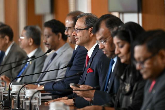 The Reserve Bank of India (RBI) Governor Sanjay Malhotra (C) addresses a press conference in Mumbai on February 6, 2026. The RBI Monetary Policy Committee (MPC) has announced unanimously that the central bank's  repo rate remains unchanged at 5.25 per cent. (Photo by Indranil Mukherjee / AFP)