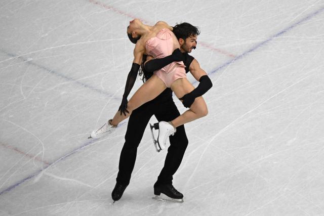 France's Laurence Fournier Beaudry and Guillaume Cizeron compete in the figure skating team event ice dance-rhythm dance during the Milano Cortina 2026 Winter Olympic Games at Milano Ice Skating Arena in Milan on February 6, 2026. (Photo by Antonin THUILLIER / AFP)