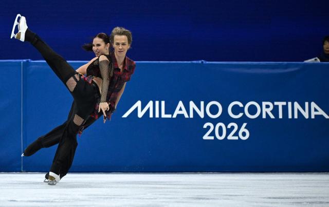 Georgia's Diana Davis (L) and Georgia's Gleb Smolkin compete in the figure skating team event ice dance-rhythm dance during the Milano Cortina 2026 Winter Olympic Games at Milano Ice Skating Arena in Milan on February 6, 2026. (Photo by WANG Zhao / AFP)