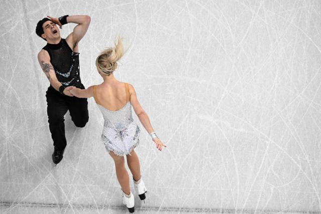 Canada's Paul Poirier (L) and Piper Gilles compete in the figure skating team event ice dance-rhythm dance during the Milano Cortina 2026 Winter Olympic Games at Milano Ice Skating Arena in Milan on February 6, 2026. (Photo by Antonin THUILLIER / AFP)
