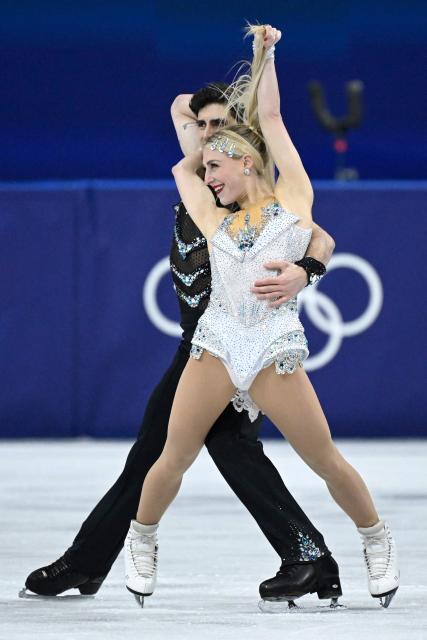 Canada's Piper Gilles (R) and Canada's Paul Poirier compete in the figure skating team event ice dance-rhythm dance during the Milano Cortina 2026 Winter Olympic Games at Milano Ice Skating Arena in Milan on February 6, 2026. (Photo by WANG Zhao / AFP)