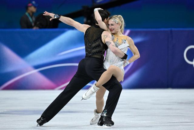 Canada's Piper Gilles (R) and Canada's Paul Poirier compete in the figure skating team event ice dance-rhythm dance during the Milano Cortina 2026 Winter Olympic Games at Milano Ice Skating Arena in Milan on February 6, 2026. (Photo by WANG Zhao / AFP)