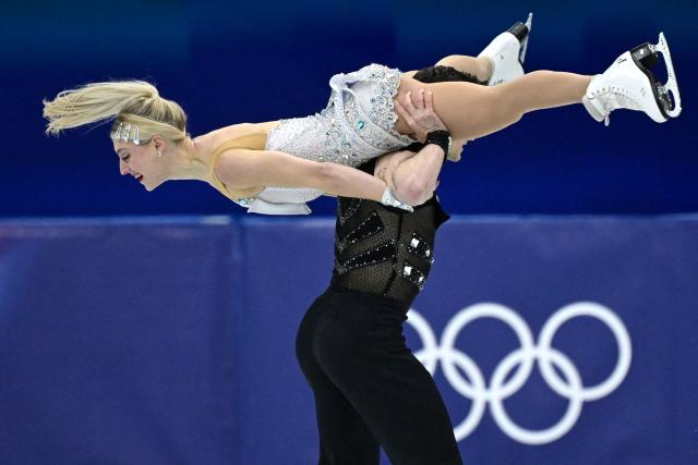 Canada's Piper Gilles (L) and Canada's Paul Poirier compete in the figure skating team event ice dance-rhythm dance during the Milano Cortina 2026 Winter Olympic Games at Milano Ice Skating Arena in Milan on February 6, 2026. (Photo by WANG Zhao / AFP)