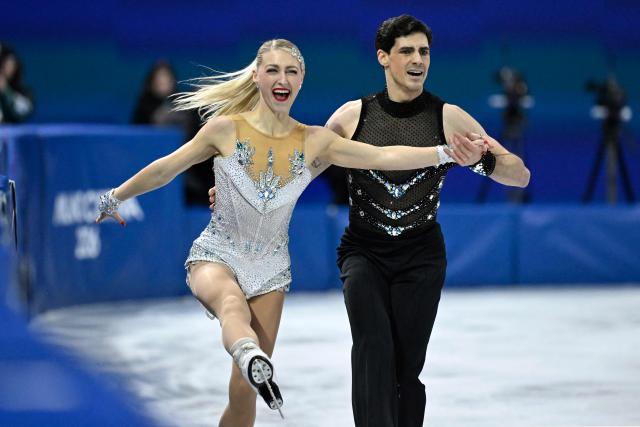 Canada's Piper Gilles (L) and Canada's Paul Poirier compete in the figure skating team event ice dance-rhythm dance during the Milano Cortina 2026 Winter Olympic Games at Milano Ice Skating Arena in Milan on February 6, 2026. (Photo by WANG Zhao / AFP)