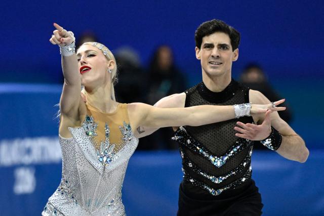 Canada's Piper Gilles (L) and Canada's Paul Poirier compete in the figure skating team event ice dance-rhythm dance during the Milano Cortina 2026 Winter Olympic Games at Milano Ice Skating Arena in Milan on February 6, 2026. (Photo by WANG Zhao / AFP)