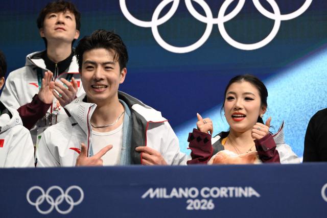 China's Wang Shiyue (R) and China's Liu Xinyu react after competing in the figure skating team event ice dance-rhythm dance during the Milano Cortina 2026 Winter Olympic Games at Milano Ice Skating Arena in Milan on February 6, 2026. (Photo by WANG Zhao / AFP)