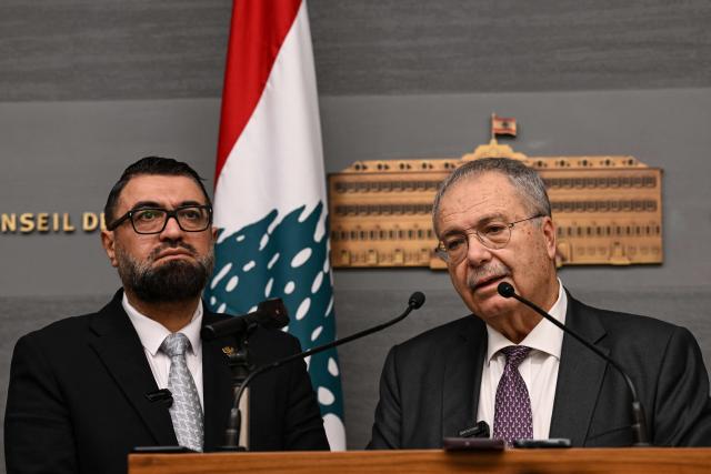 Syria's Justice Minister Mazhar al-Wais (L) and Lebanese Deputy Prime Minister Tarek Metri speak during a press conference  following the signing of a prisoner swap agreement, at the Grand Serail (Government Palace) in Beirut on February 6, 2026. (Photo by JOSEPH EID / AFP)