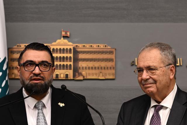 Syria's Justice Minister Mazhar al-Wais (L) and Lebanese Deputy Prime Minister Tarek Metri speak during a press conference  following the signing of a prisoner swap agreement, at the Grand Serail (Government Palace) in Beirut on February 6, 2026. (Photo by JOSEPH EID / AFP)