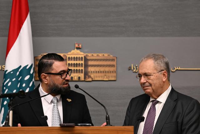 Syria's Justice Minister Mazhar al-Wais (L) and Lebanese Deputy Prime Minister Tarek Metri speak during a press conference  following the signing of a prisoner swap agreement, at the Grand Serail (Government Palace) in Beirut on February 6, 2026. (Photo by JOSEPH EID / AFP)