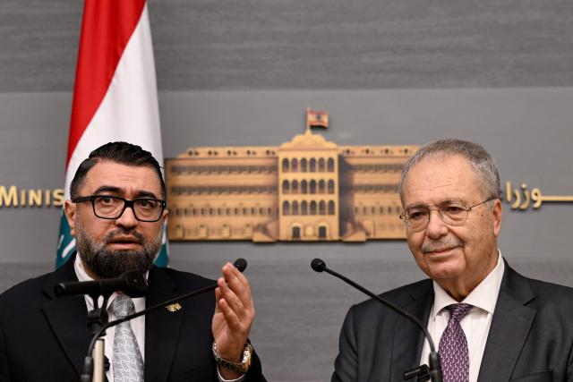Syria's Justice Minister Mazhar al-Wais (L) and Lebanese Deputy Prime Minister Tarek Metri speak during a press conference  following the signing of a prisoner swap agreement, at the Grand Serail (Government Palace) in Beirut on February 6, 2026. (Photo by JOSEPH EID / AFP)