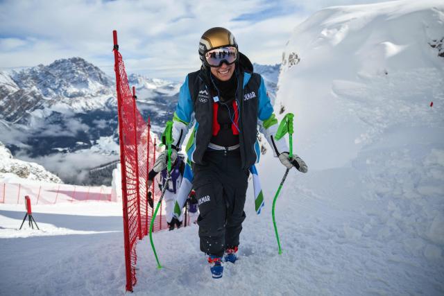 Slovenia's Ilka Stuhec climbs the slope before the second official training for the women's downhill event ahead of the Milano Cortina 2026 Winter Olympic Games at the Tofane Alpine Skiing Centre in Cortina d’Ampezzo on February 6, 2026. (Photo by Marco BERTORELLO / AFP)