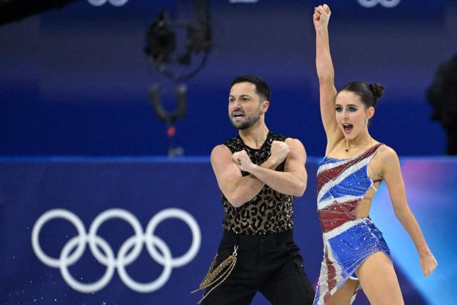Britain's Lilah Fear (R) and Britain's Lewis Gibson compete in the figure skating team event ice dance-rhythm dance during the Milano Cortina 2026 Winter Olympic Games at Milano Ice Skating Arena in Milan on February 6, 2026. (Photo by WANG Zhao / AFP)