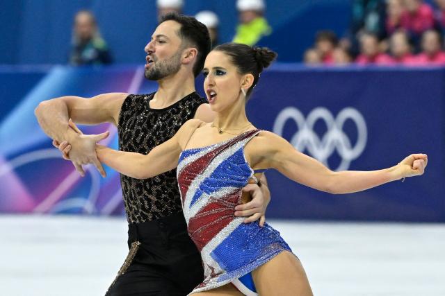 Britain's Lilah Fear (R) and Britain's Lewis Gibson compete in the figure skating team event ice dance-rhythm dance during the Milano Cortina 2026 Winter Olympic Games at Milano Ice Skating Arena in Milan on February 6, 2026. (Photo by WANG Zhao / AFP)