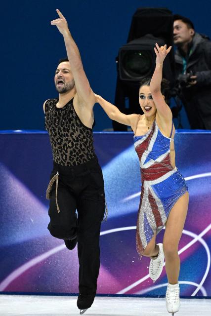 Britain's Lilah Fear (R) and Britain's Lewis Gibson compete in the figure skating team event ice dance-rhythm dance during the Milano Cortina 2026 Winter Olympic Games at Milano Ice Skating Arena in Milan on February 6, 2026. (Photo by WANG Zhao / AFP)