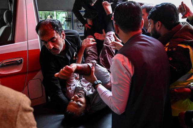 EDITORS NOTE: Graphic content / People shift an injured man to a hospital following an explosion at a mosque in Islamabad on February 6, 2026. A blast at a Shiite mosque in Pakistan's capital Islamabad on February 6 killed 11 people and wounded 20, a police source told AFP. (Photo by Aamir QURESHI / AFP)