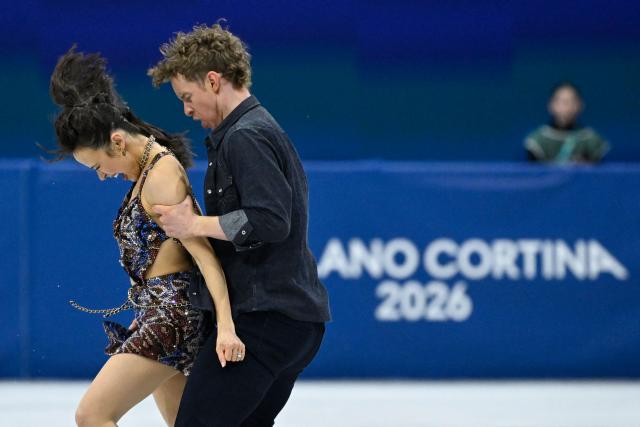 USA's Madison Chock (L) and USA's Evan Bates compete in the figure skating team event ice dance-rhythm dance during the Milano Cortina 2026 Winter Olympic Games at Milano Ice Skating Arena in Milan on February 6, 2026. (Photo by WANG Zhao / AFP)