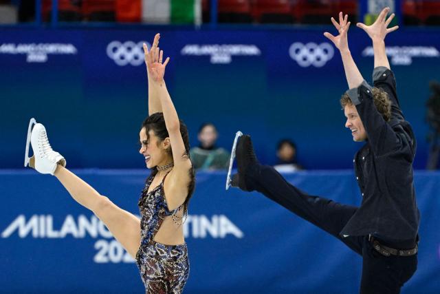 USA's Madison Chock (L) and USA's Evan Bates compete in the figure skating team event ice dance-rhythm dance during the Milano Cortina 2026 Winter Olympic Games at Milano Ice Skating Arena in Milan on February 6, 2026. (Photo by WANG Zhao / AFP)