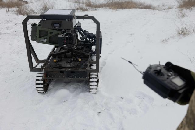 A Ukrainian serviceman of the 30th separate mechanized brigade prepares a robotic combat vehicle armed with an Mk 19 grenade launcher to test at an undisclosed location in Donetsk region on January 27, 2026, amid the Russian invasion of Ukraine. (Photo by Tetiana DZHAFAROVA / AFP)