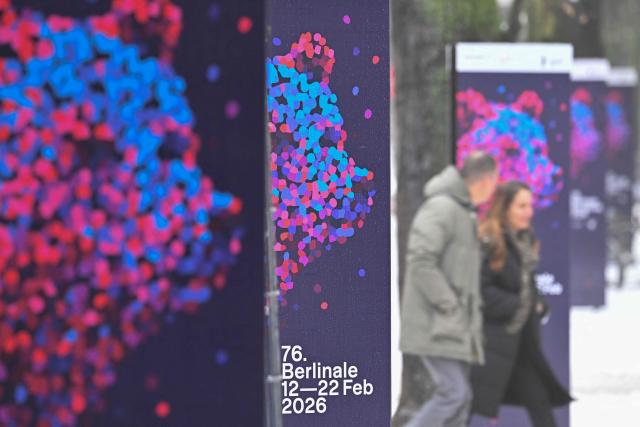 Pedestrians walk past advertising posters of the 76th Berlin International Film Festival 'Berlinale' in front of the Berlinale Palace in Berlin, on February 6, 2026. The 76th Berlinale edition will be running from February 12 to 22, 2026. (Photo by RALF HIRSCHBERGER / AFP)