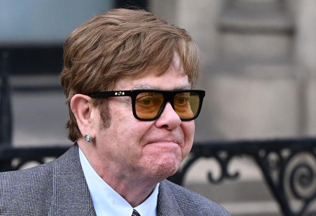 (FILES) English singer Elton John leaves the Royal Courts of Justice, Britain's High Court, in central London on March 27, 2023. Pop icon Elton John on Friday, February 6, accused the publisher of two UK tabloids of "abhorrent" privacy invasions "outside even the most basic standards of human decency" as he testified at London's High Court. (Photo by JUSTIN TALLIS / AFP)