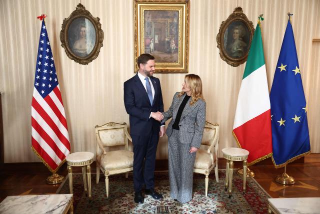 U.S. Vice President JD Vance (L) is welcomed by Italian Prime Minister Giorgia Meloni (R) ahead of their meeting as part of his visit to the Milano Cortina 2026 Winter Olympics in Milan on February 6, 2026. (Photo by Kevin Lamarque / AFP)