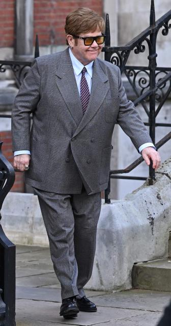 (FILES) English singer Elton John leaves the Royal Courts of Justice, Britain's High Court, in central London on March 27, 2023. Pop icon Elton John on Friday, February 6, accused the publisher of two UK tabloids of "abhorrent" privacy invasions "outside even the most basic standards of human decency" as he testified at London's High Court. (Photo by JUSTIN TALLIS / AFP)