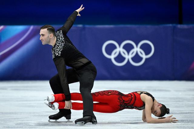 Georgia's Anastasiia Metelkina and Luka Berulava compete in the figure skating pair short program during the Milano Cortina 2026 Winter Olympic Games at Milano Ice Skating Arena in Milan on February 6, 2026. (Photo by WANG Zhao / AFP)