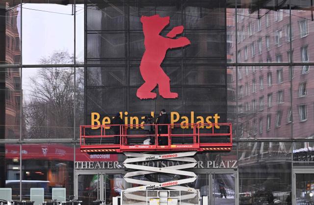 Workers mount the Berlinale bear on the facade of the Berlinale Palace the festival's main venue as preparations for the Berlin International Film Festival Berlinale are under way in Berlin, on February 6, 2026. The festival's 76th edition takes place from February 12 to 22, 2026. (Photo by RALF HIRSCHBERGER / AFP)