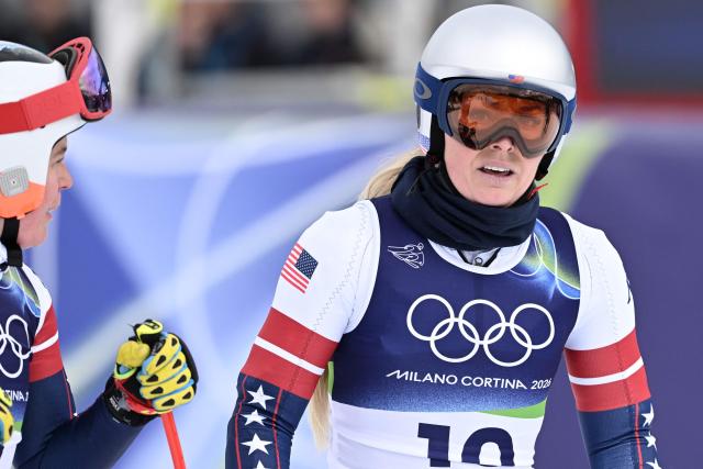 USA's Breezy Johnson (L) looks on as USA's Lindsey Vonn reacts after taking part in the second official training for the women's downhill event ahead of the Milano Cortina 2026 Winter Olympic Games at the Tofane Alpine Skiing Centre in Cortina d’Ampezzo on February 6, 2026. (Photo by Tiziana FABI / AFP)