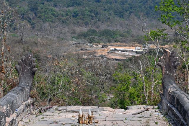 Thai bunkers (C) are seen in front of the Preah Vihear temple in Preah Vihear province on February 6, 2026. Chunks of broken sandstone litter Cambodia's UNESCO-listed Preah Vihear temple, whose centuries-old sandstone facades are pocked with fresh shrapnel scars after weeks of deadly border clashes with neighbouring Thailand. Considered a masterpiece of Khmer architecture that looks out over the northern Cambodian plains, the temple became a war zone when a longstanding border dispute erupted into fighting with jets, artillery, tanks and ground troops last year. (Photo by TANG CHHIN Sothy / AFP) / To go with 'CAMBODIA-THAILAND-CONFLICT-HERITAGE, REPORTAGE' by Suy SE
