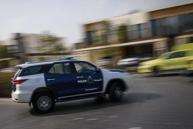 An Omani police vehicle drives past in Muscat, on February 6, 2026. (Photo by Loic VENANCE / AFP)