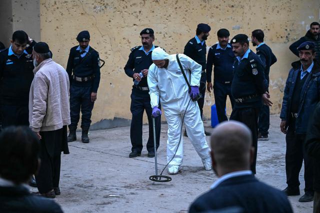 An investigator uses metal detectors to search the blast site following a suicide bombing at the Shiite mosque in Islamabad on February 6, 2026. A suicide bombing at a Shiite mosque in Pakistan's capital Islamabad killed at least 31 people on February 6, according to authorities, with a police source saying more than 130 were wounded. (Photo by Farooq NAEEM / AFP)