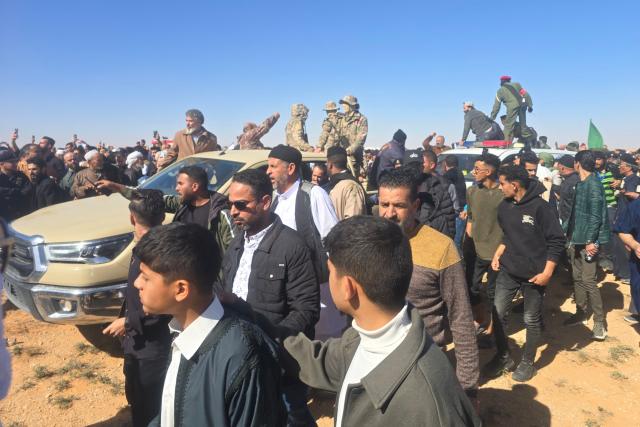 Libyans gather for the funeral of Seif al-Islam Gaddafi, the son of Libya's late longtime ruler, in Bani Walid, in the Tripoli region, western Libya on February 6, 2026. Seif al-Islam, 53, the son of Libya's late longtime ruler, had been seen by some as his father's successor, despite being targeted by a warrant from the International Criminal Court for alleged crimes against humanity. He was killed on February 3, 2026, by gunmen who stormed his home in western Libya's Zintan, his French lawyer told AFP. (Photo by Mahmud Turkia / AFP)