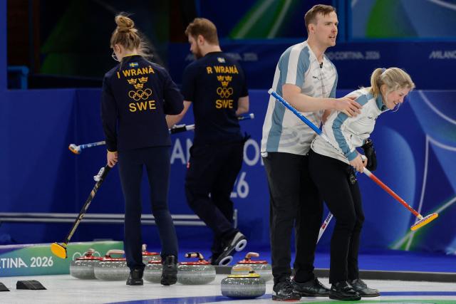 Norway's Magnus Nedregotten (2nd R) and Norway's Kristin Skaslien (R) celebrate after winning the curling mixed doubles round robin between Sweden and Norway during the Milano Cortina 2026 Winter Olympic Games at the Cortina Curling Olympic Stadium in Cortina d’Ampezzo on February 6, 2026. (Photo by Odd ANDERSEN / AFP)