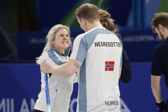 Norway's Magnus Nedregotten (R) and Norway's Kristin Skaslien (L) celebrate after winning the curling mixed doubles round robin between Sweden and Norway during the Milano Cortina 2026 Winter Olympic Games at the Cortina Curling Olympic Stadium in Cortina d’Ampezzo on February 6, 2026. (Photo by Odd ANDERSEN / AFP)