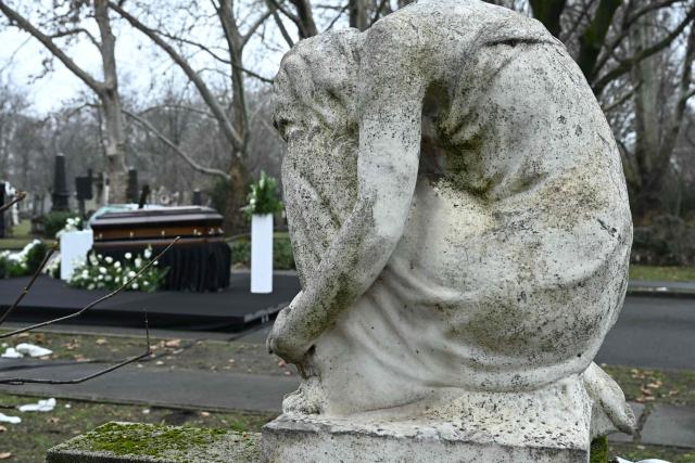 The coffin of Hungarian filmmaker Bela Tarr is displayed on his funeral at the Fiumei Road Cemetery of Budapest, Hungary, on February 6, 2026, one month after his death. Legendary Hungarian filmmaker Bela Tarr, known for his long takes, monochromatic movies and depictions of desolate landscapes on the silver screen, died on January 6, 2026 at the age of 70. Tarr was best known for the movie "Satantango (1994), a seven-hour epic about the collapse of communism in Eastern Europe and its material and spiritual decline. (Photo by Attila KISBENEDEK / AFP)