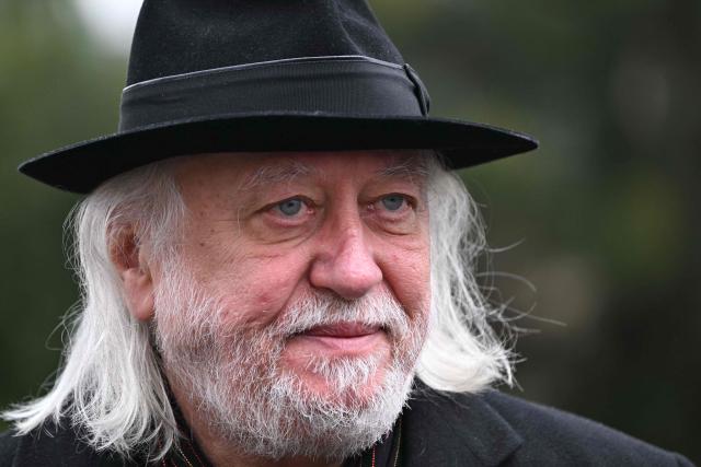 Hungarian writer and winner of the 2025 Nobel Prize in Literature Laszlo Krasznahorkai looks on during the funeral of Hungarian filmmaker Bela Tarr at the Fiumei Road Cemetery of Budapest, Hungary, on February 6, 2026, one month after his death. Legendary Hungarian filmmaker Bela Tarr, known for his long takes, monochromatic movies and depictions of desolate landscapes on the silver screen, died on January 6, 2026 at the age of 70. Tarr was best known for the movie "Satantango (1994), a seven-hour epic about the collapse of communism in Eastern Europe and its material and spiritual decline. (Photo by Attila KISBENEDEK / AFP)