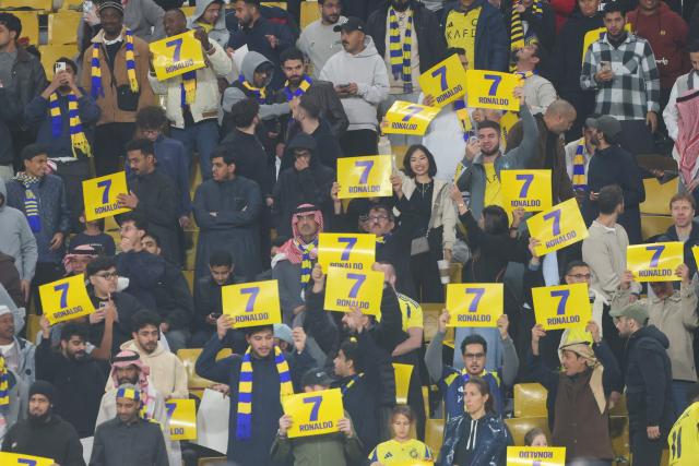Supporter hold placards showing the name of Nassr's Portuguese forward #07 Cristiano Ronaldo ahead of the Saudi Pro League football match between Al-Nassr and Al-Ittihad at Al-Awwal Park Stadium, in Riyadh on February 6, 2026. (Photo by Fayez NURELDINE / AFP)